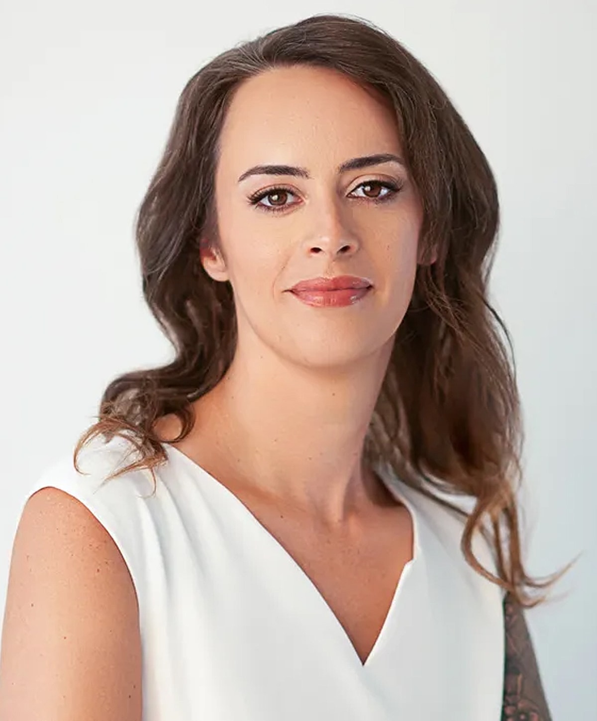 Person with long hair in a white blouse.