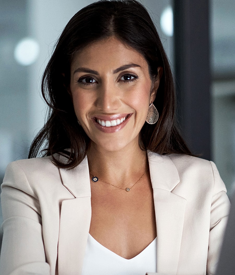 Smiling Melbourne facial cosmetic surgery model in a professional blazer.