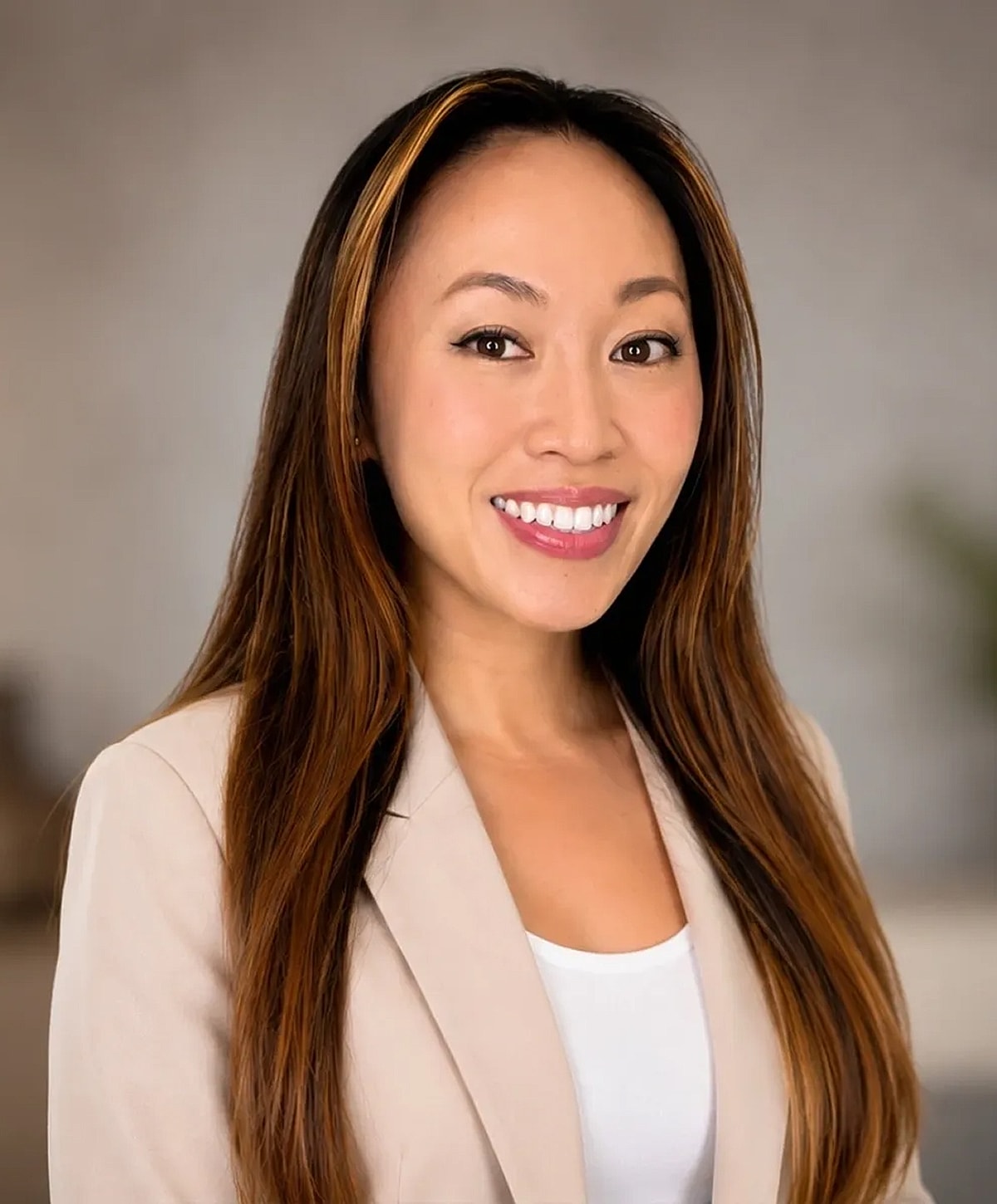 Smiling woman in a professional outfit portrait.