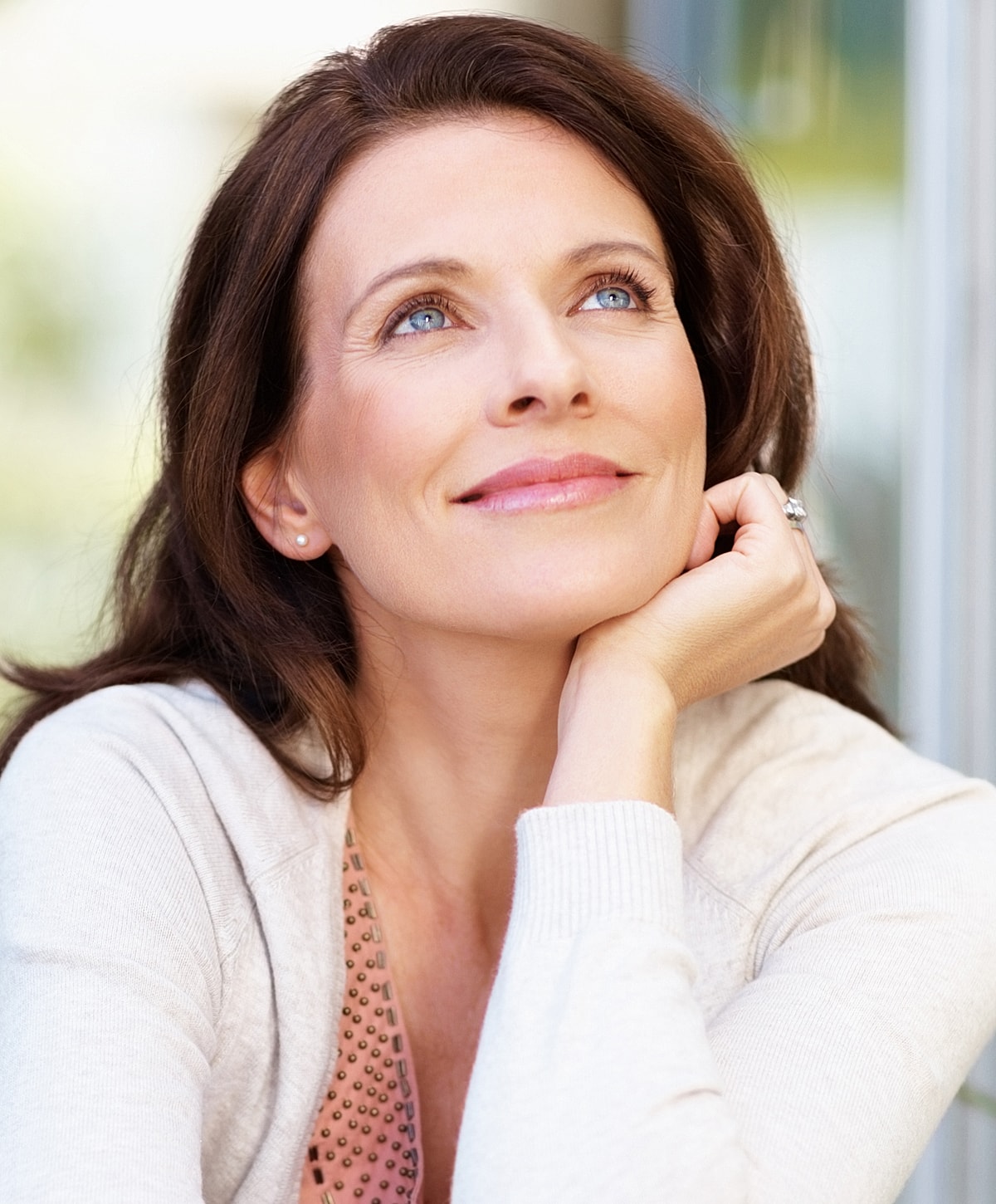 Woman looking thoughtfully with a serene expression.
