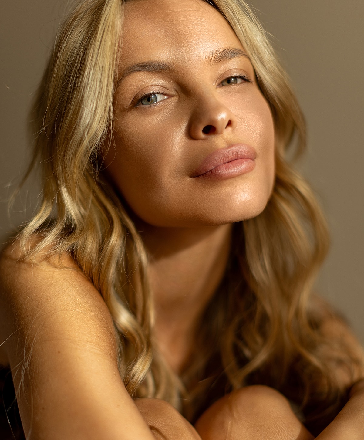 Close-up of a woman with wavy blonde hair.