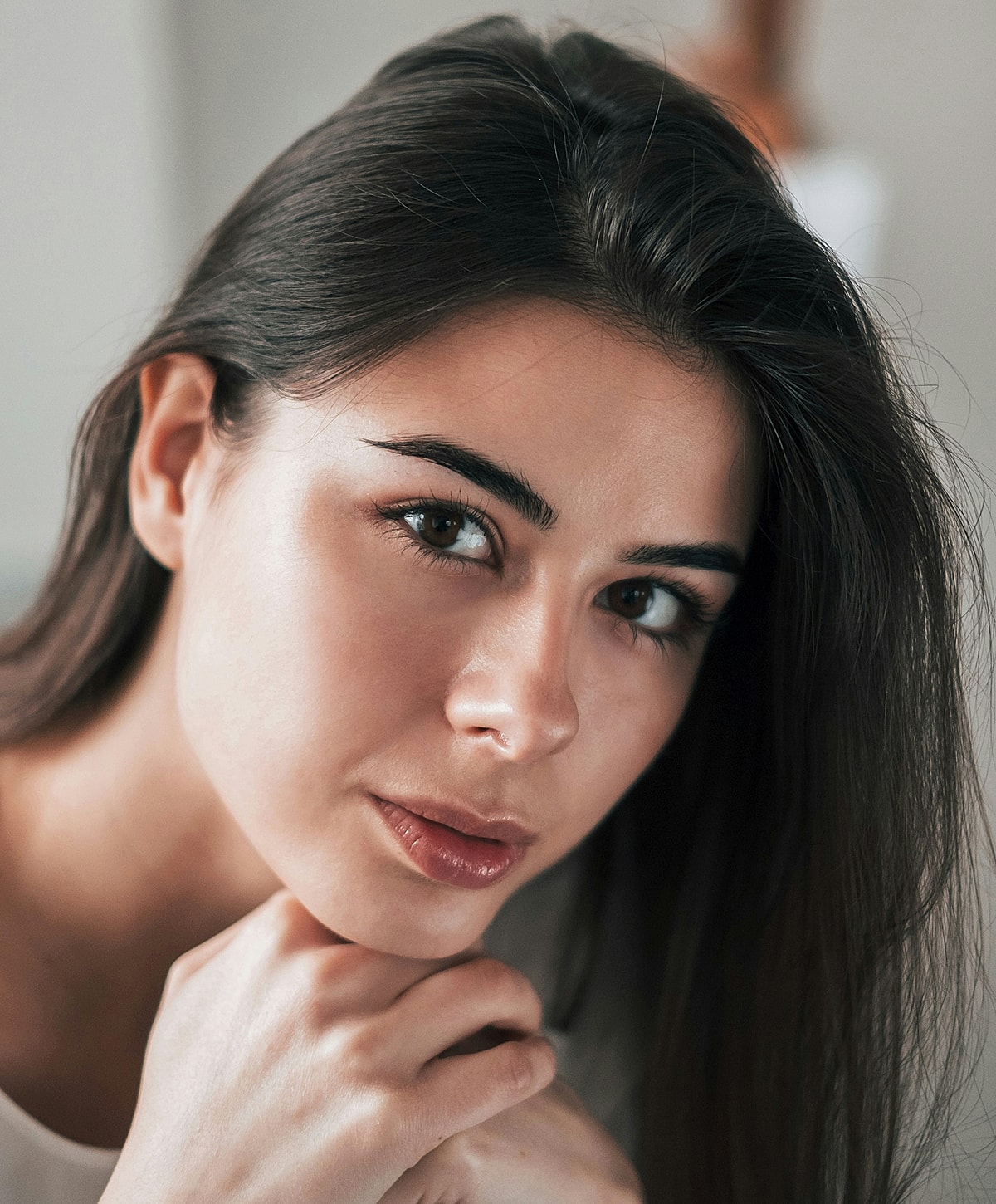 Close-up of a woman's face with soft expression.