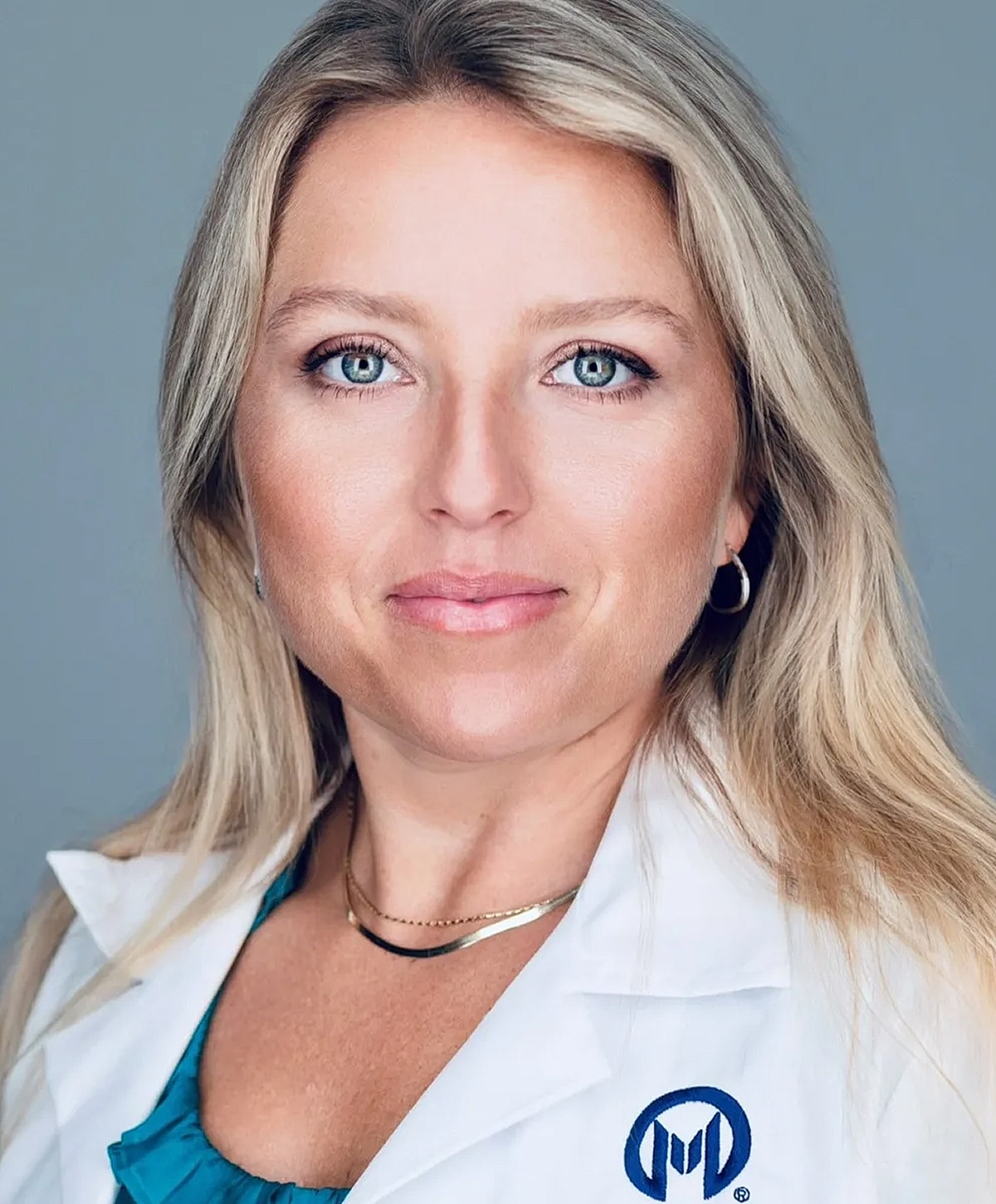Professional portrait of a woman in lab coat.