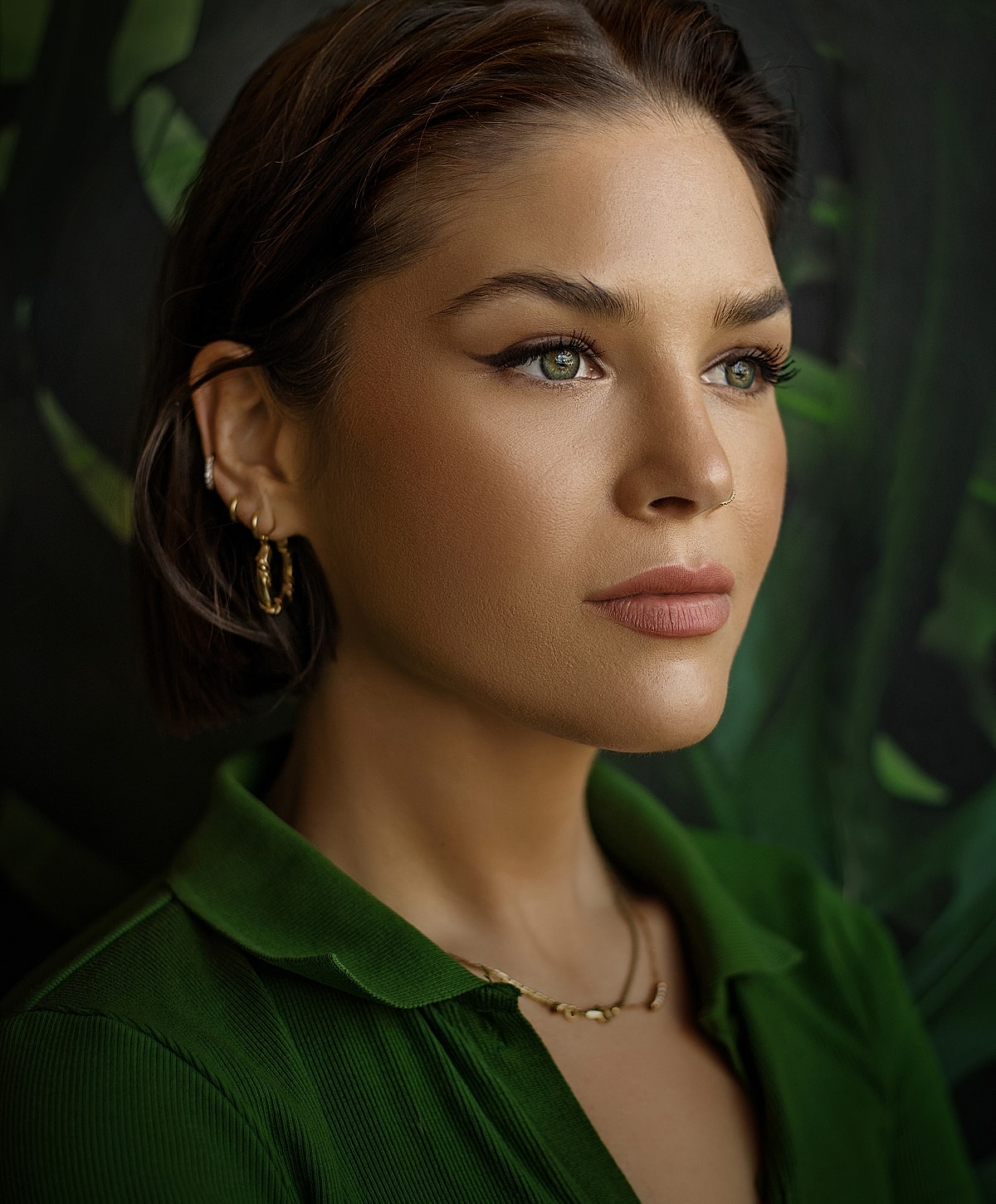 Woman with green eyes in a green top.