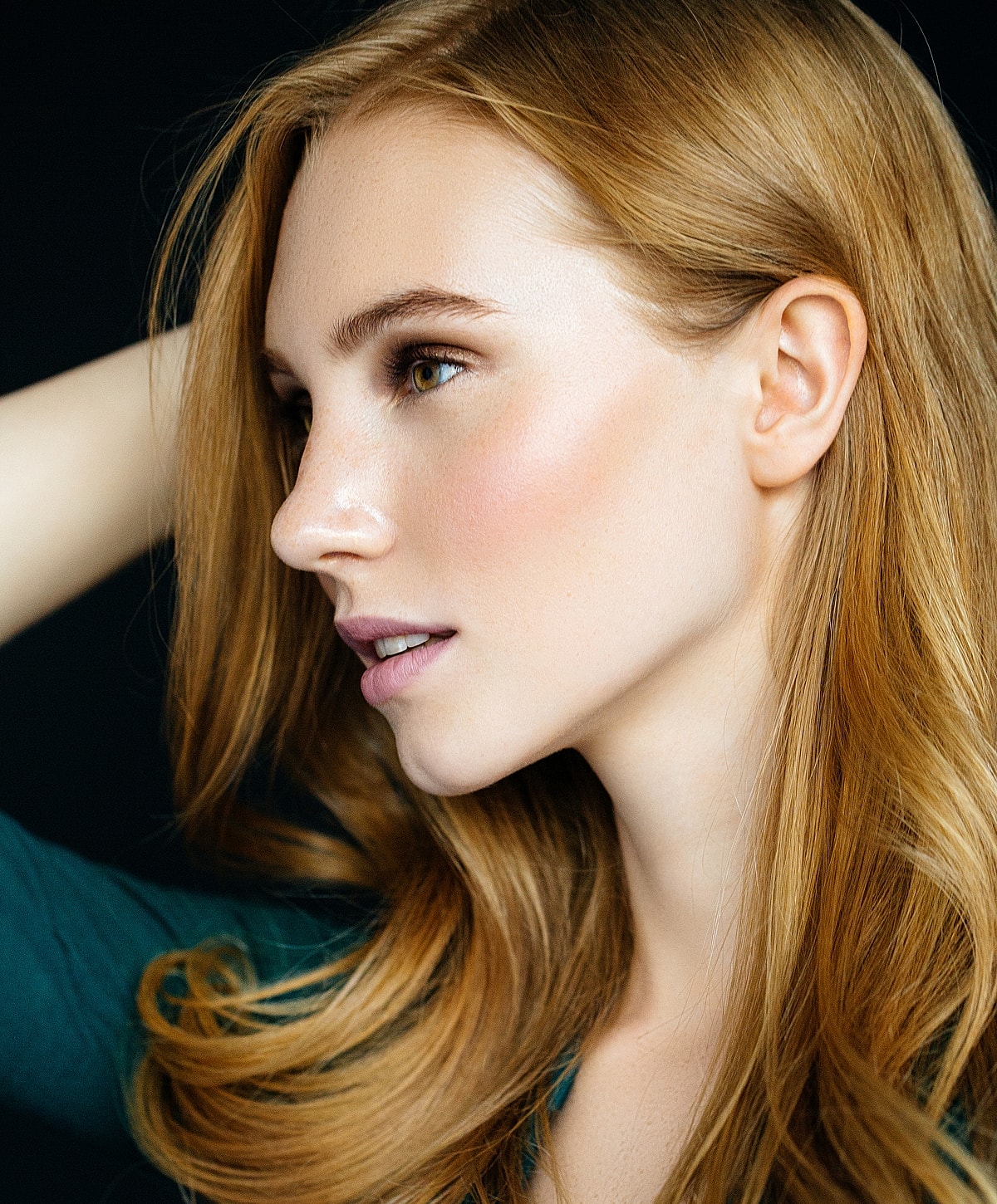 Profile of a woman with long, wavy hair.