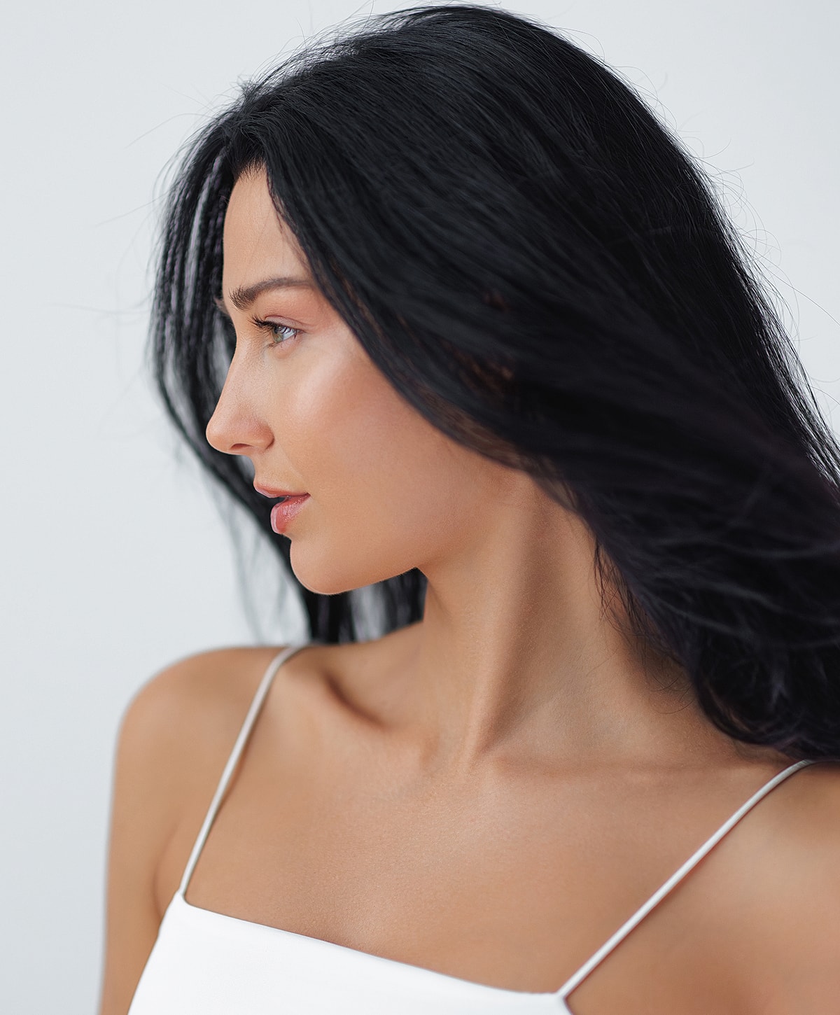 Woman with long black hair in profile.
