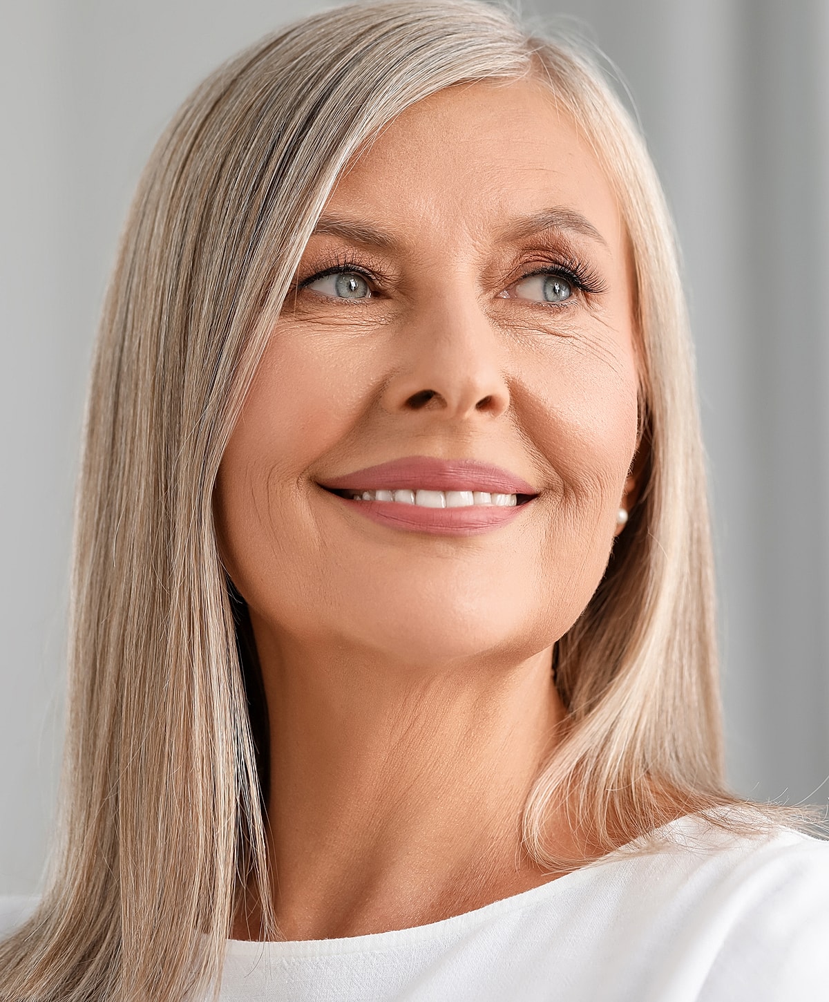 Smiling older woman with long, silver hair.