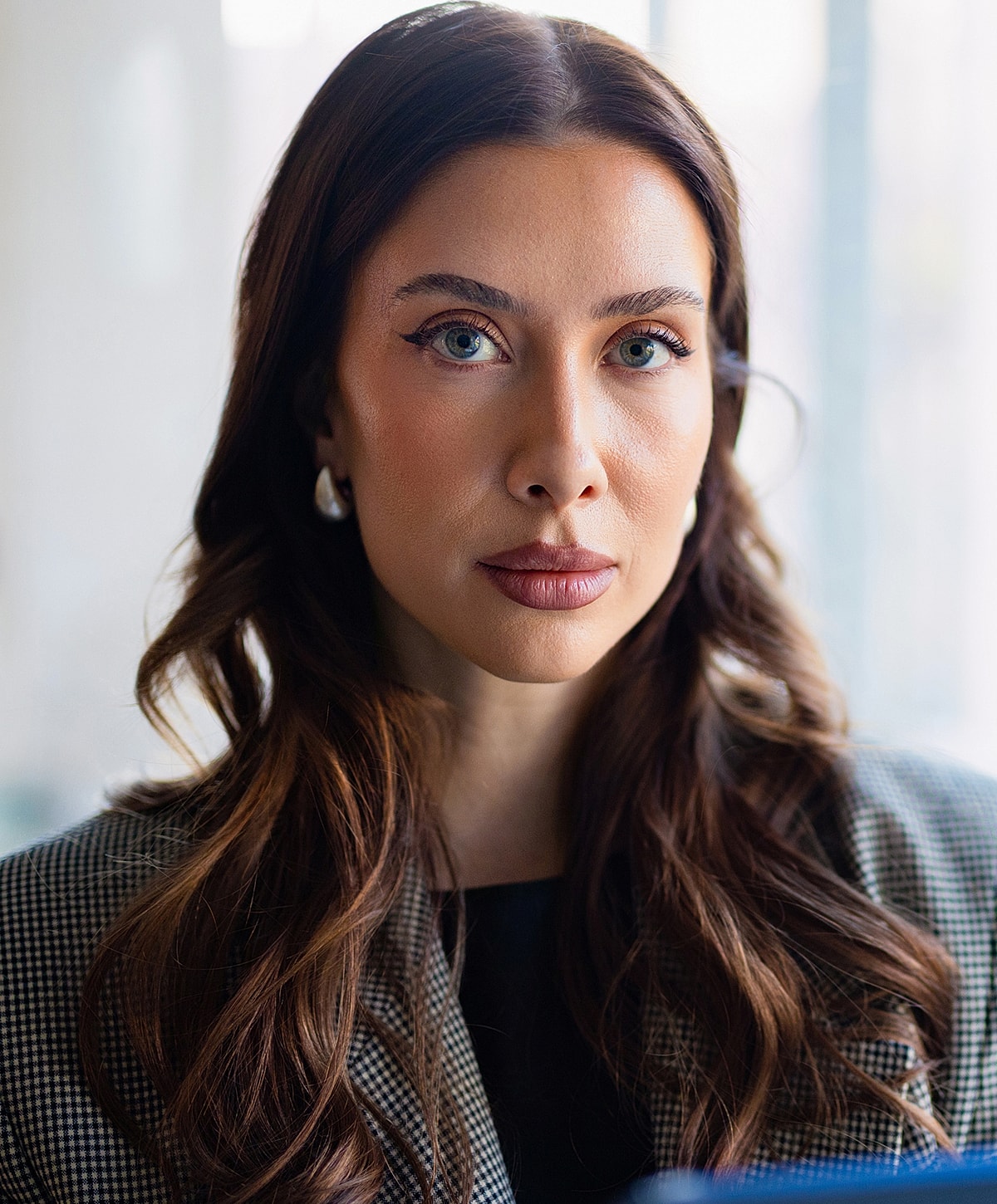 Professional Melbourne biostimulator model with long hair and piercing eyes.