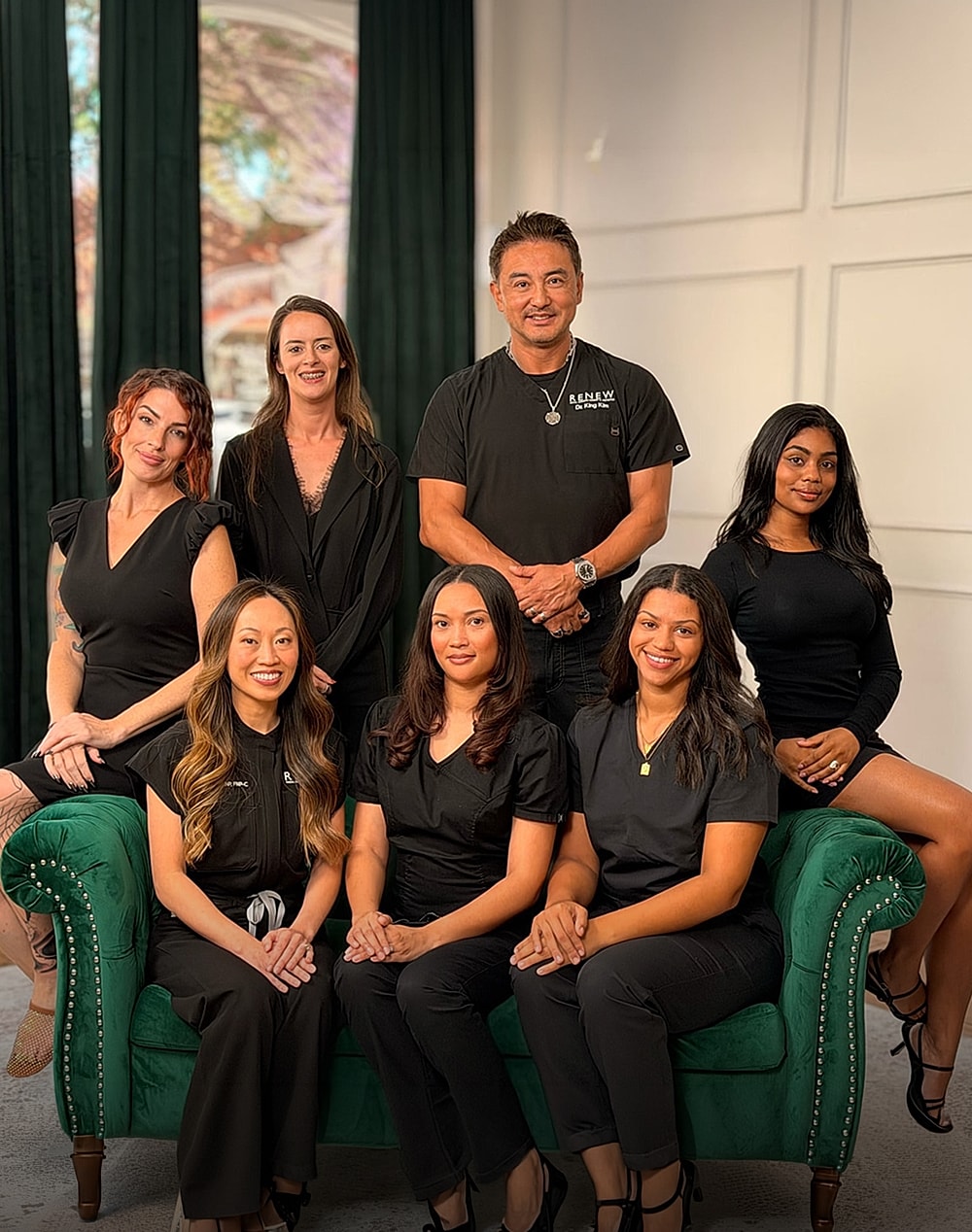 Medical team posing together in black scrubs.