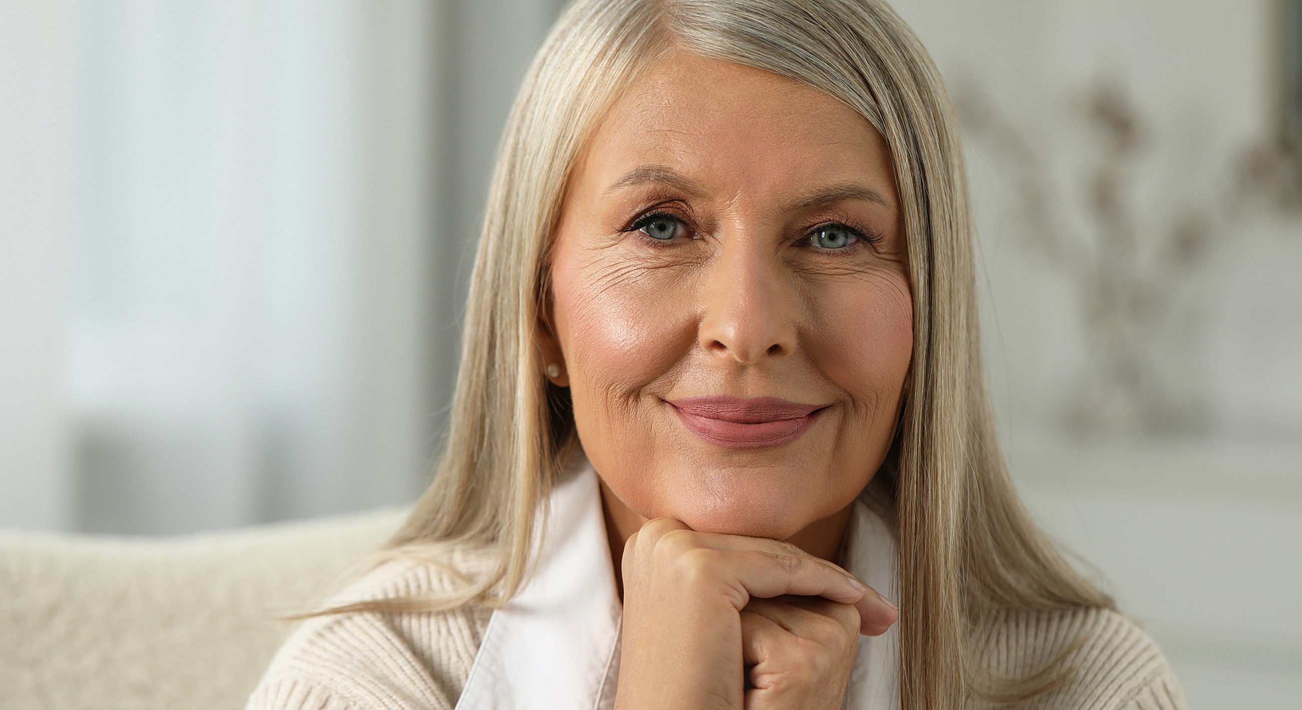 Smiling older woman with gray hair indoors.