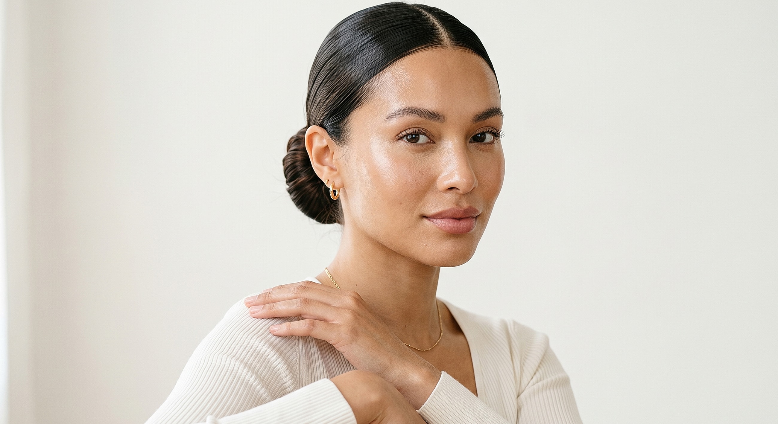 Woman in natural light with elegant hairstyle.